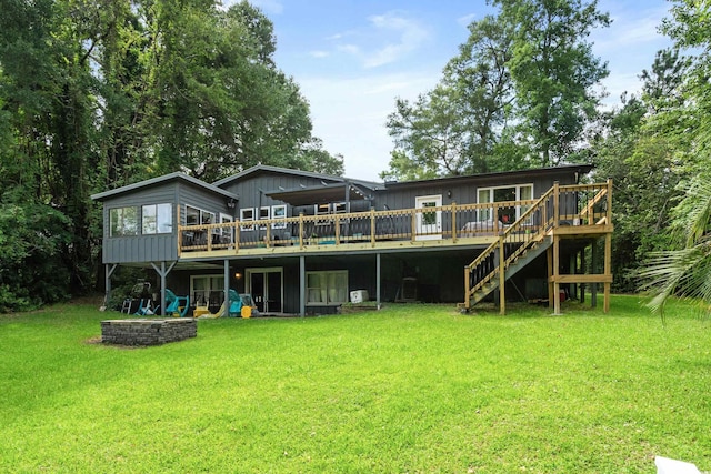 rear view of property featuring a deck and a lawn