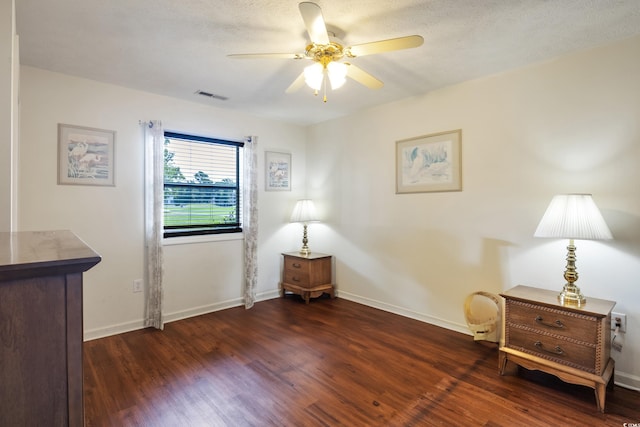 sitting room featuring a textured ceiling, dark hardwood / wood-style floors, and ceiling fan