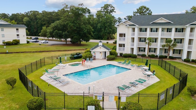 view of pool with a lawn and a patio area