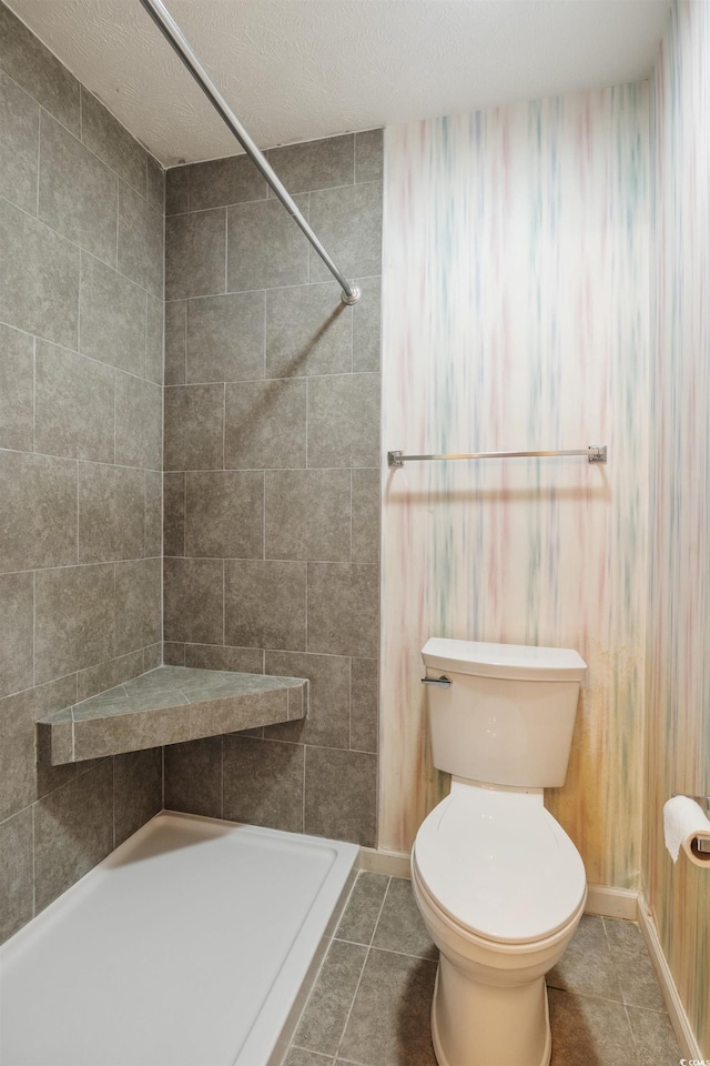 bathroom featuring walk in shower, tile patterned floors, a textured ceiling, and toilet