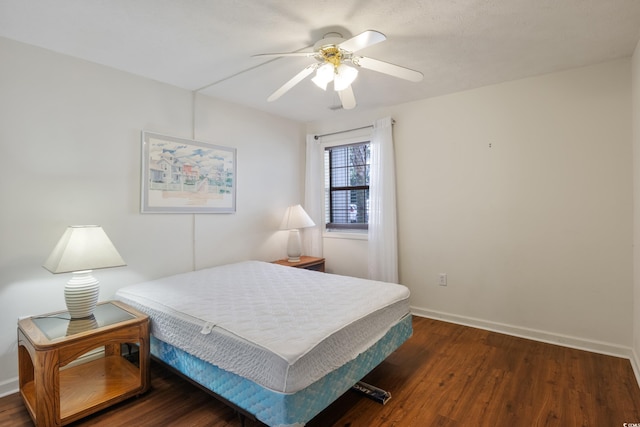 bedroom with ceiling fan and dark wood-type flooring