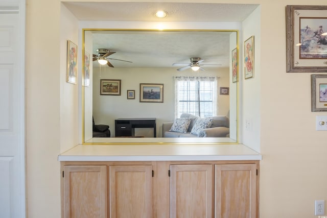 interior space with ceiling fan