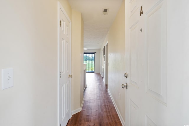 corridor featuring dark wood-type flooring