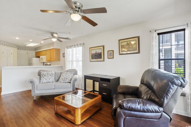 living room with dark hardwood / wood-style floors and ceiling fan