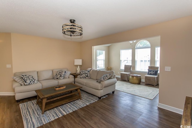 living room featuring wood finished floors and baseboards