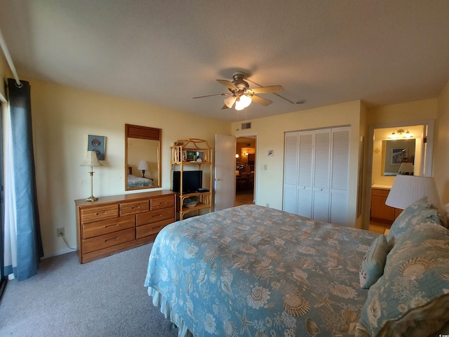 bedroom with ceiling fan, a closet, carpet floors, and ensuite bath