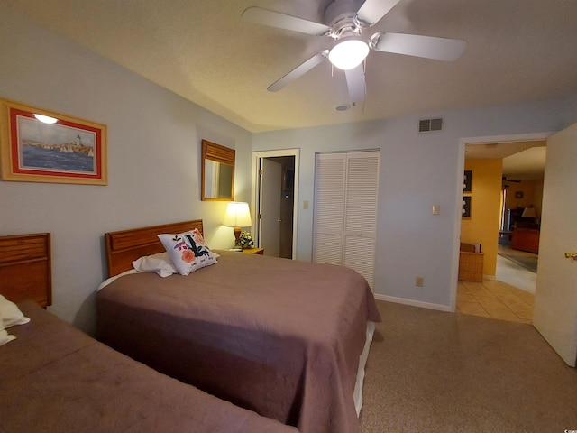 bedroom with a closet, carpet, and ceiling fan