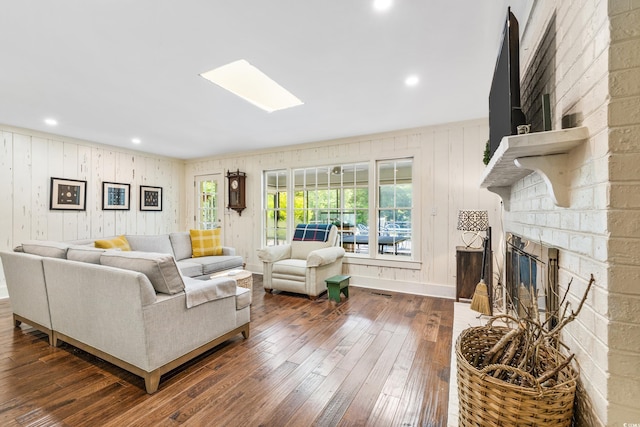 living room featuring dark hardwood / wood-style flooring and a fireplace