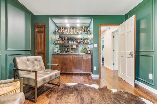 bar with hardwood / wood-style floors