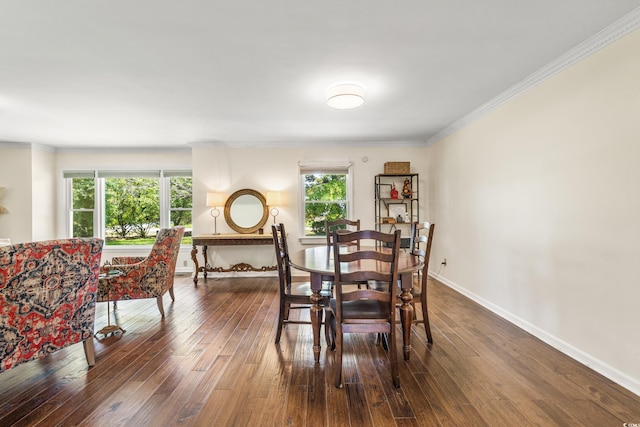 dining area featuring dark hardwood / wood-style floors and ornamental molding