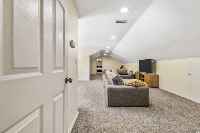 carpeted living room featuring vaulted ceiling