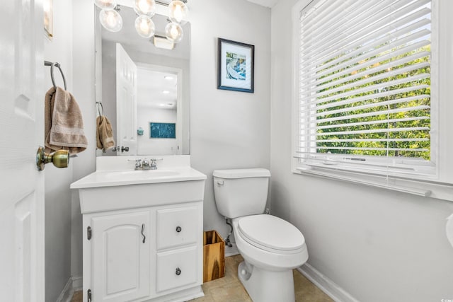 bathroom featuring tile patterned floors, vanity, and toilet