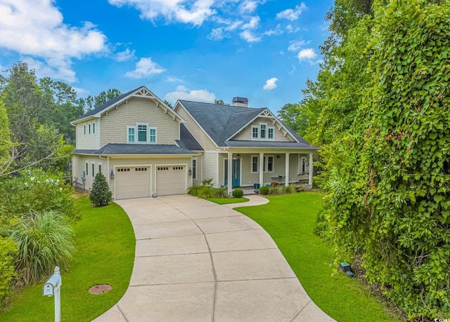 craftsman-style house with a front yard, a garage, and a porch