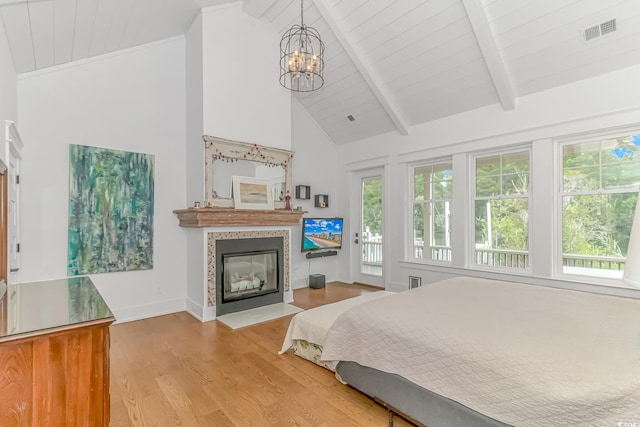 bedroom with beamed ceiling, high vaulted ceiling, a chandelier, and light hardwood / wood-style floors