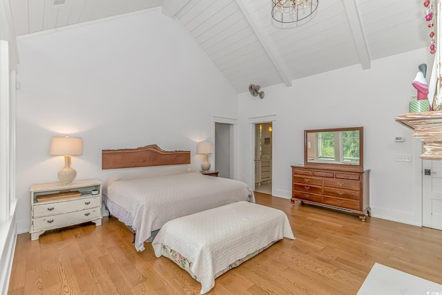 bedroom with connected bathroom, light hardwood / wood-style flooring, high vaulted ceiling, and beamed ceiling