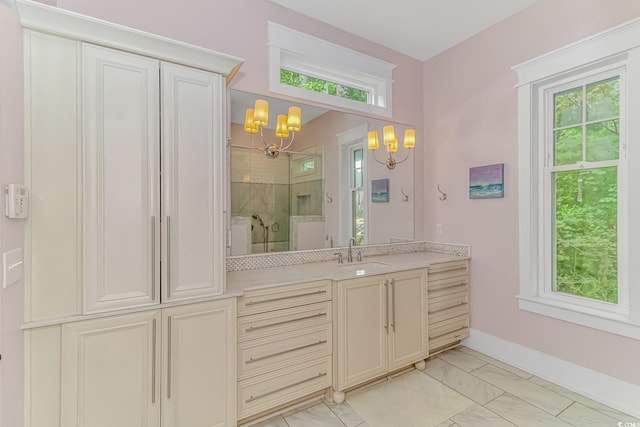 bathroom with an enclosed shower, vanity, and a chandelier