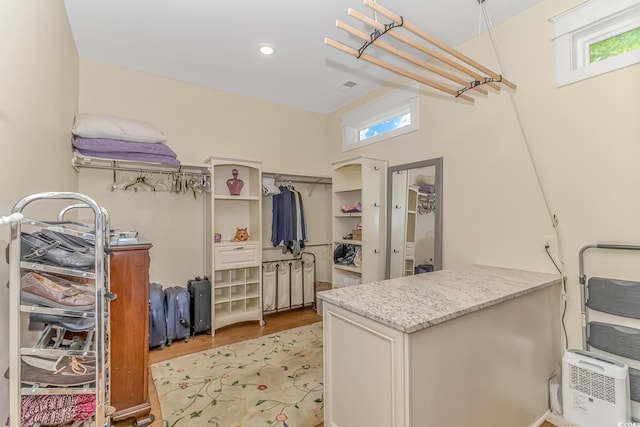 walk in closet featuring light hardwood / wood-style flooring