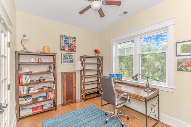 office with ceiling fan and light hardwood / wood-style flooring