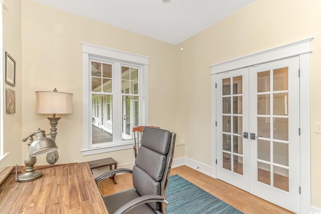 home office featuring light wood-type flooring and french doors