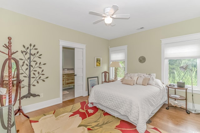 bedroom featuring connected bathroom, ceiling fan, and light hardwood / wood-style floors