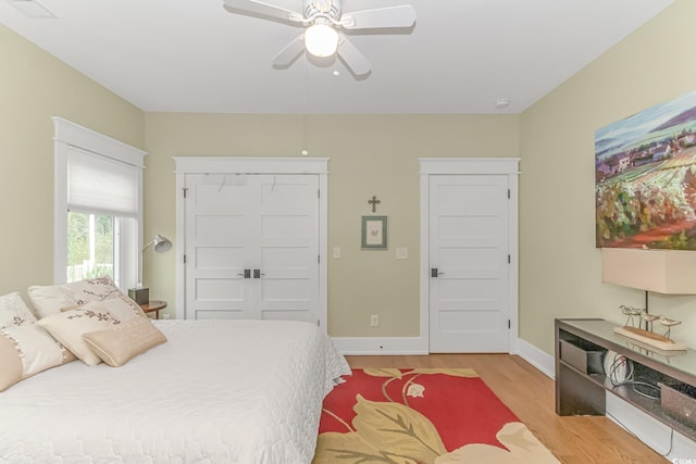 bedroom featuring light wood-type flooring, a closet, and ceiling fan