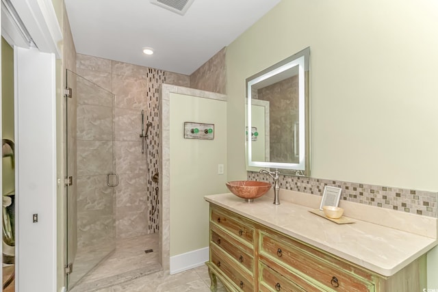 bathroom featuring vanity, a shower with door, and tile patterned flooring