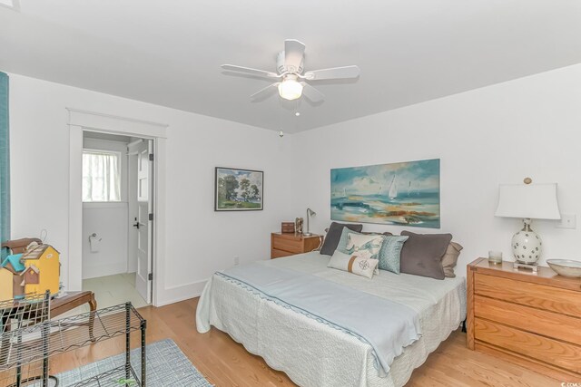 bedroom featuring light hardwood / wood-style flooring, connected bathroom, and ceiling fan