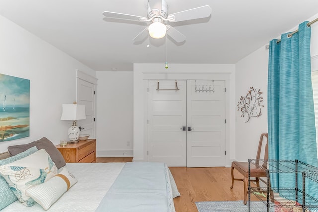 bedroom featuring light hardwood / wood-style flooring, a closet, and ceiling fan