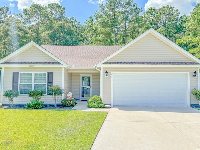 view of front of property with a front yard and a garage