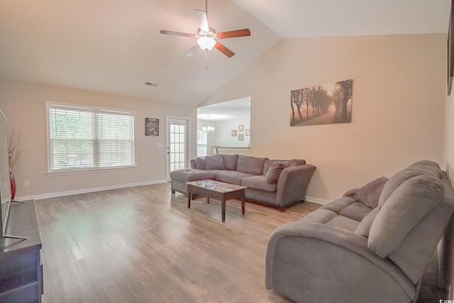 living room with ceiling fan, light hardwood / wood-style flooring, and high vaulted ceiling