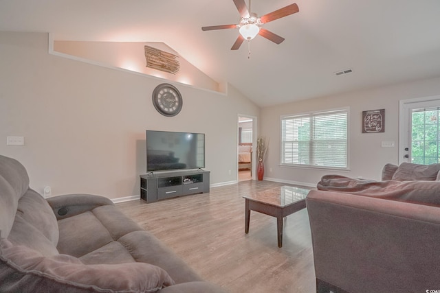 kitchen with white fridge, lofted ceiling, a kitchen breakfast bar, light hardwood / wood-style floors, and ceiling fan with notable chandelier