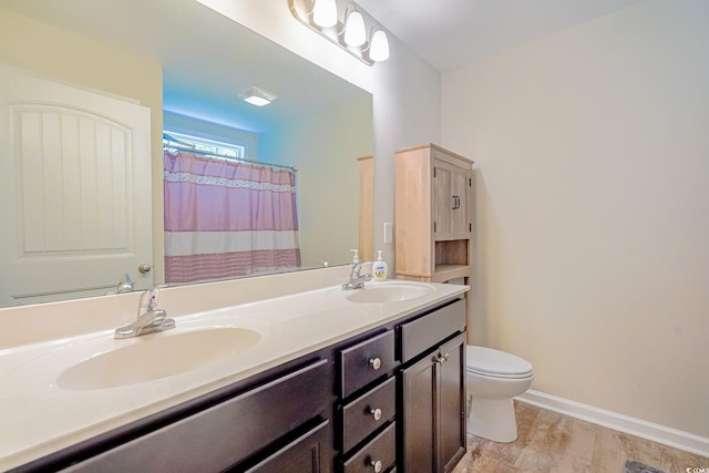 bathroom with toilet, walk in shower, wood-type flooring, and sink