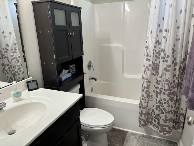 full bathroom with toilet, hardwood / wood-style flooring, shower / tub combo with curtain, and sink