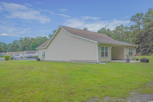view of home's exterior featuring a patio and a yard