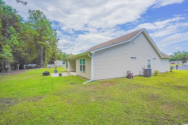 rear view of property featuring a yard and a patio