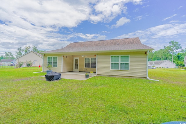 rear view of house featuring a lawn and a patio area