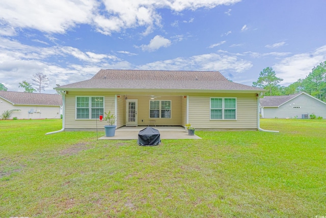 rear view of property featuring a yard and a patio area