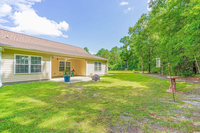 view of side of property featuring a yard and a patio area