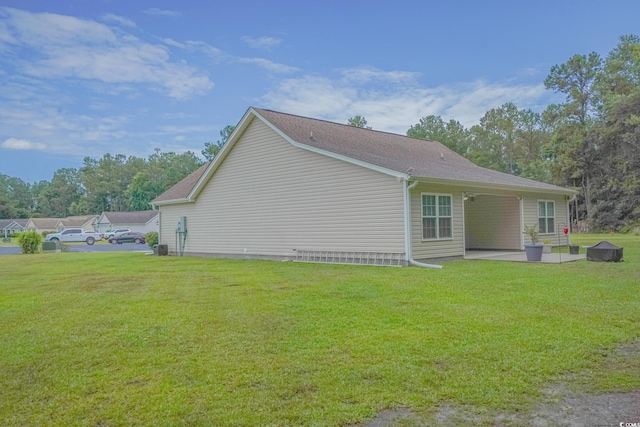 view of side of property with a lawn and a patio