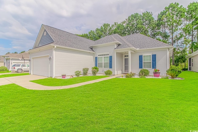 view of front of property featuring a front lawn and a garage