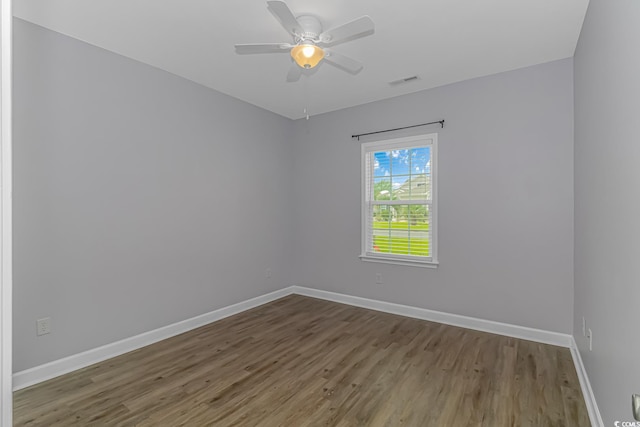 empty room featuring hardwood / wood-style flooring and ceiling fan