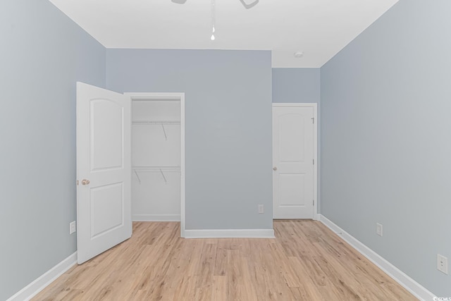 unfurnished bedroom with a closet and light hardwood / wood-style flooring