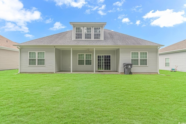 rear view of property featuring a patio area, a yard, and ceiling fan