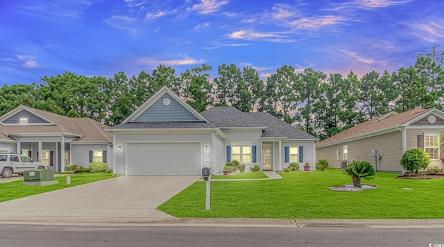 view of front facade with a garage and a lawn