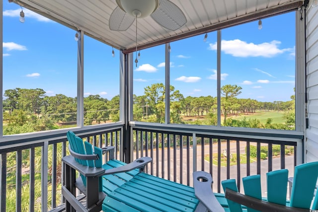 sunroom / solarium featuring ceiling fan