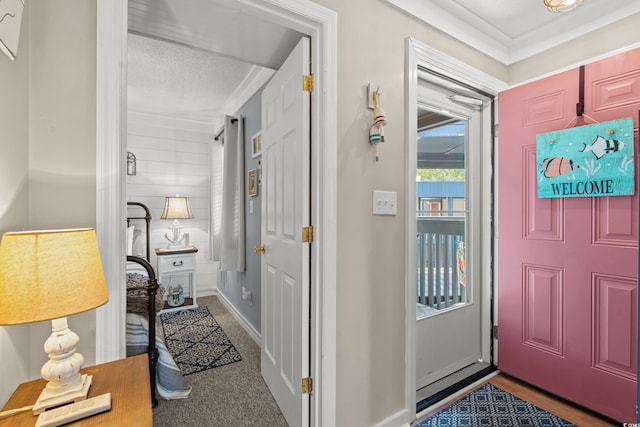 foyer entrance featuring carpet and baseboards