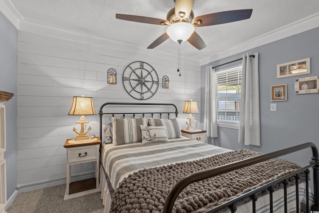 bedroom with a textured ceiling, carpet flooring, and a ceiling fan