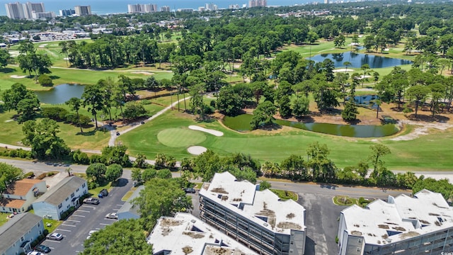 birds eye view of property featuring view of golf course, a water view, and a city view