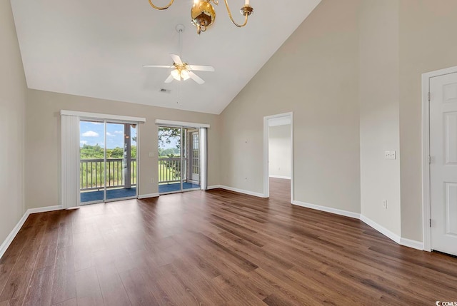 spare room featuring high vaulted ceiling, ceiling fan with notable chandelier, and hardwood / wood-style floors