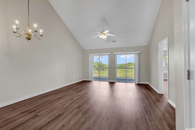 spare room featuring dark hardwood / wood-style flooring, ceiling fan with notable chandelier, and high vaulted ceiling